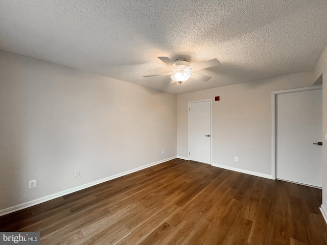 empty room featuring hardwood / wood-style flooring, a textured ceiling, and ceiling fan