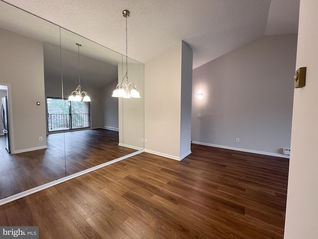 unfurnished dining area featuring a chandelier, a textured ceiling, dark hardwood / wood-style flooring, and baseboard heating