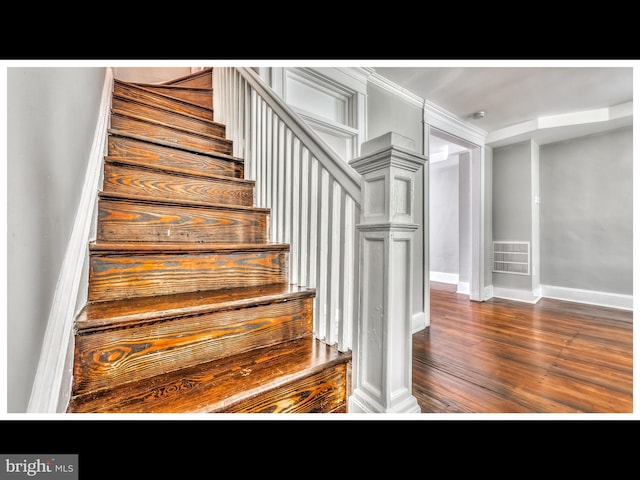 stairs featuring hardwood / wood-style flooring