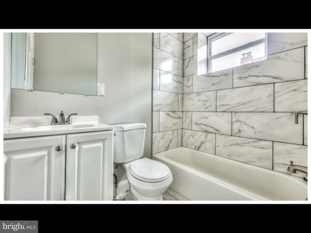 full bathroom featuring tiled shower / bath, vanity, and toilet