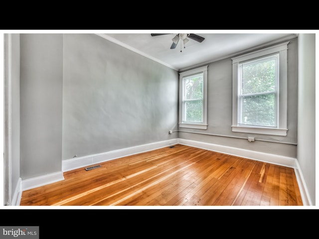 spare room with ceiling fan, ornamental molding, and hardwood / wood-style floors