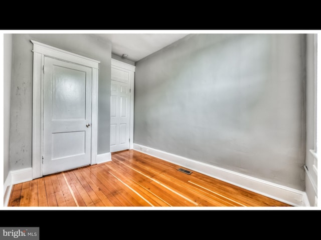 unfurnished bedroom with hardwood / wood-style flooring