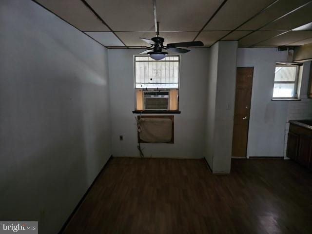 empty room with hardwood / wood-style floors, a drop ceiling, ceiling fan, and cooling unit