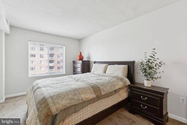 carpeted bedroom featuring a textured ceiling