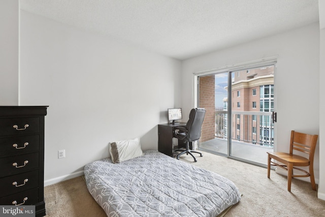 bedroom featuring carpet floors, a textured ceiling, and access to outside