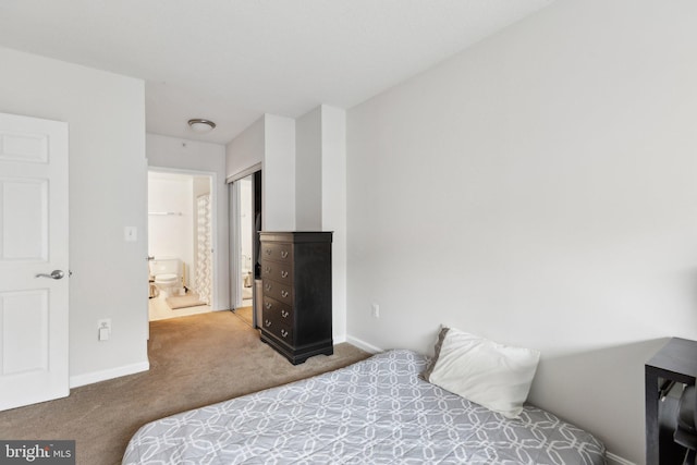 carpeted bedroom featuring ensuite bathroom