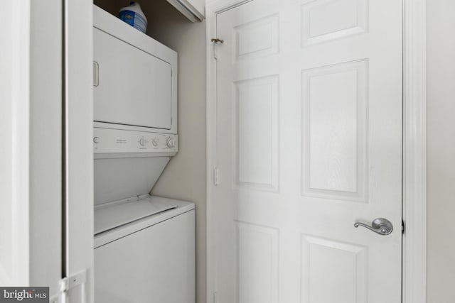 washroom featuring stacked washer and dryer