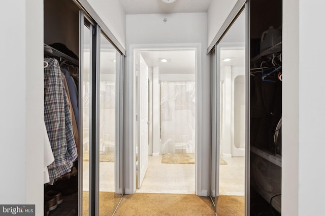 corridor featuring light tile patterned flooring