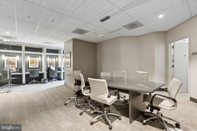 carpeted home office with a paneled ceiling