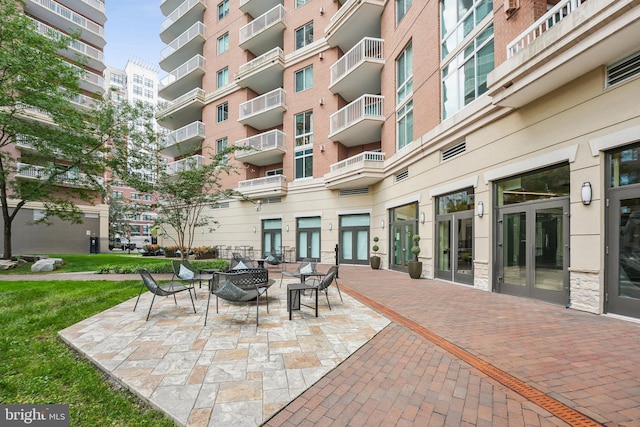 view of patio / terrace with french doors and an outdoor fire pit