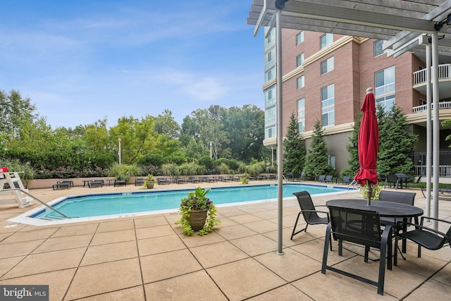 view of swimming pool featuring a pergola and a patio area