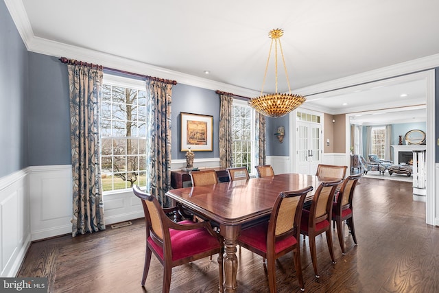 dining area featuring dark wood-style floors and plenty of natural light