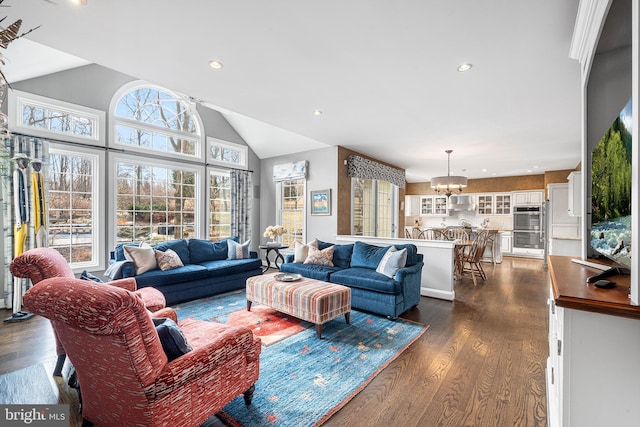 living room featuring vaulted ceiling, dark wood finished floors, a notable chandelier, and recessed lighting