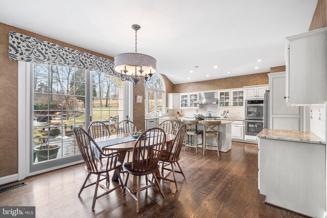 dining space featuring dark wood-style floors, recessed lighting, visible vents, and an inviting chandelier