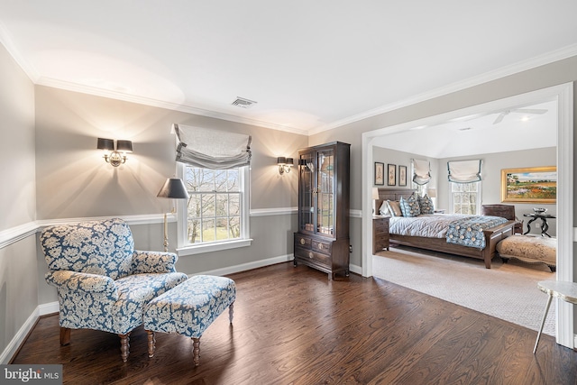 bedroom with baseboards, visible vents, ornamental molding, and wood finished floors