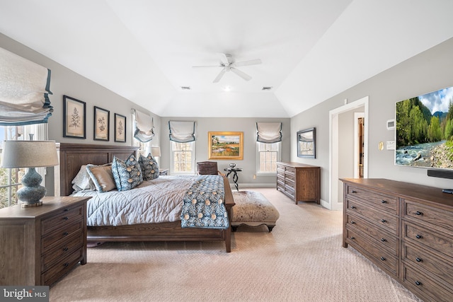 bedroom featuring light colored carpet, a ceiling fan, baseboards, vaulted ceiling, and visible vents