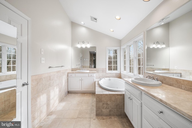 bathroom with lofted ceiling, tile patterned flooring, visible vents, and a sink