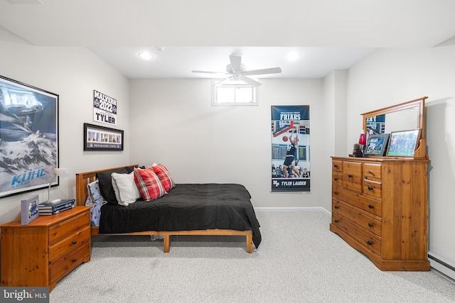 carpeted bedroom with ceiling fan, a baseboard heating unit, baseboards, and recessed lighting