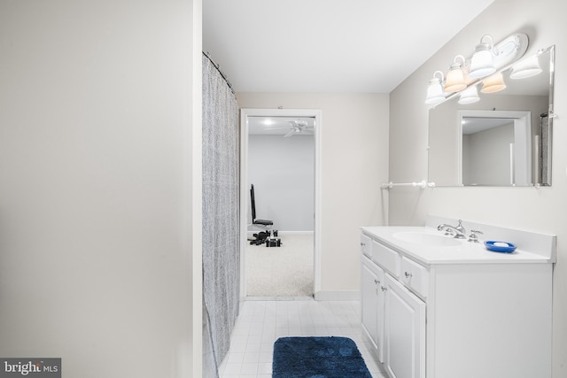 bathroom featuring vanity, baseboards, and tile patterned floors