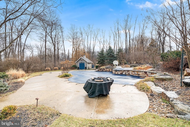 view of swimming pool with an outbuilding and a patio area