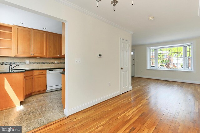 kitchen with crown molding, white dishwasher, open shelves, dark countertops, and baseboards