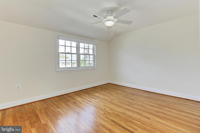 empty room featuring light wood-style floors, a ceiling fan, baseboards, and visible vents