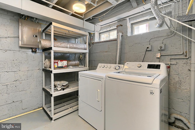 laundry area featuring laundry area, electric panel, and washer and dryer