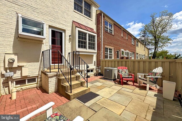 view of patio with fence and central AC unit