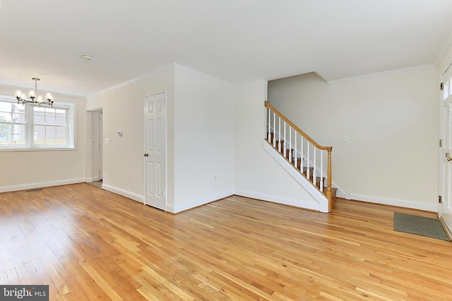 entryway featuring crown molding, stairs, a chandelier, and light wood-style floors