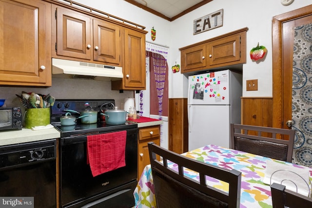 kitchen with crown molding and black appliances