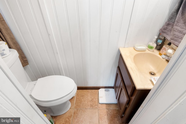 bathroom featuring vanity, tile patterned floors, and toilet