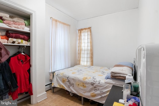 tiled bedroom featuring a baseboard radiator