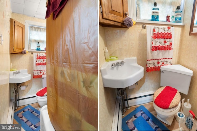 bathroom with a baseboard radiator, toilet, and sink