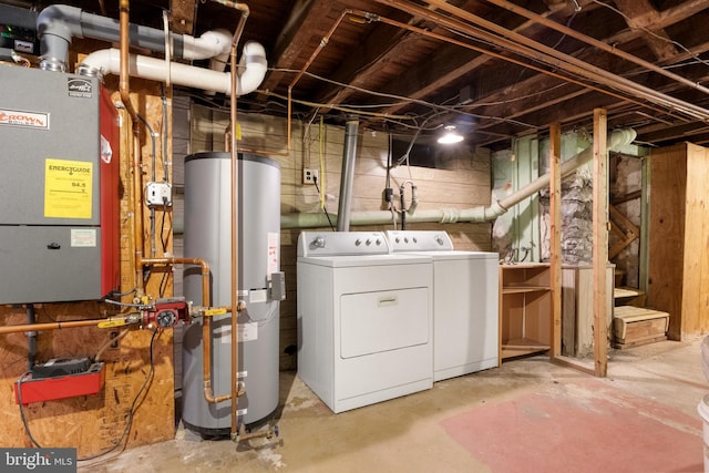 laundry room with water heater and independent washer and dryer