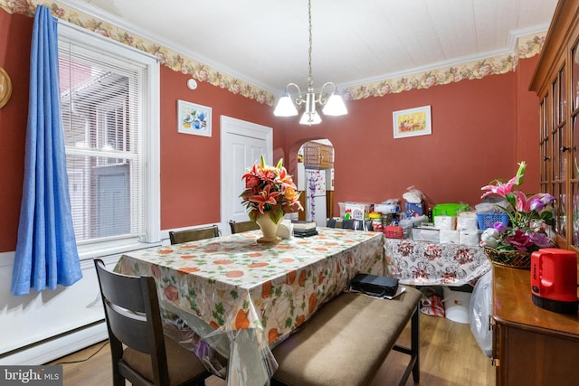 dining area with a notable chandelier, crown molding, a baseboard radiator, and light hardwood / wood-style floors