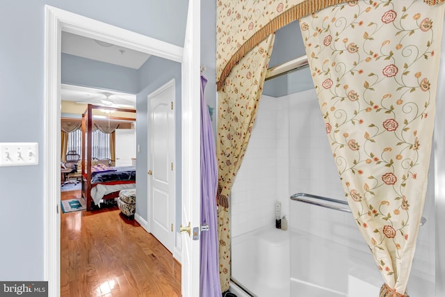 bathroom with hardwood / wood-style flooring and walk in shower