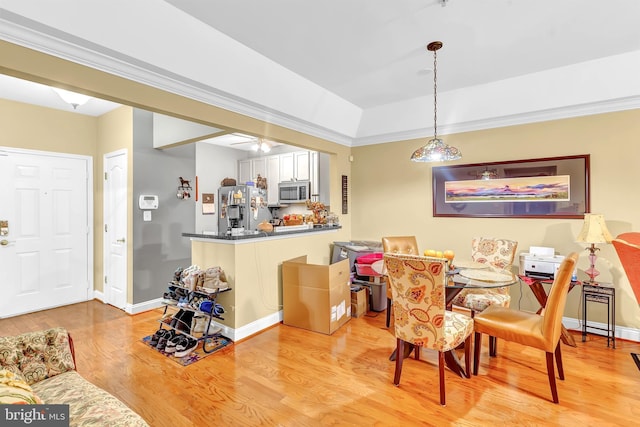 dining room featuring crown molding and light hardwood / wood-style floors