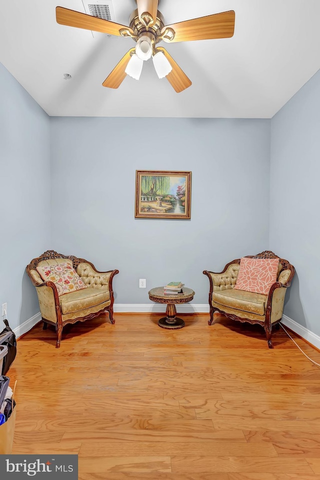 living area featuring ceiling fan and light wood-type flooring