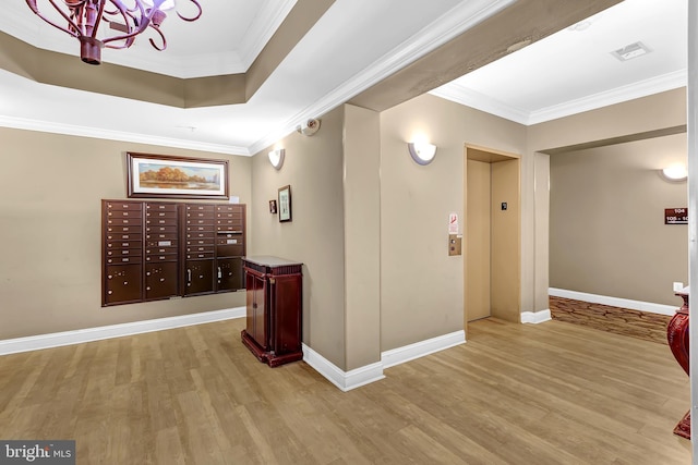 hall featuring crown molding, elevator, mail boxes, and light wood-type flooring