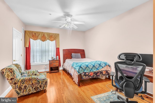 bedroom with ceiling fan and light hardwood / wood-style flooring