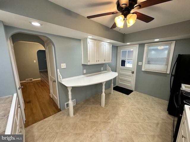 kitchen with white cabinetry, light tile patterned floors, and ceiling fan