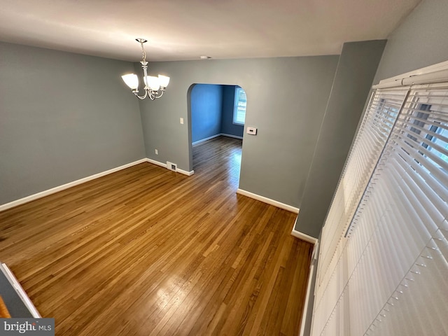 interior space with an inviting chandelier and hardwood / wood-style floors