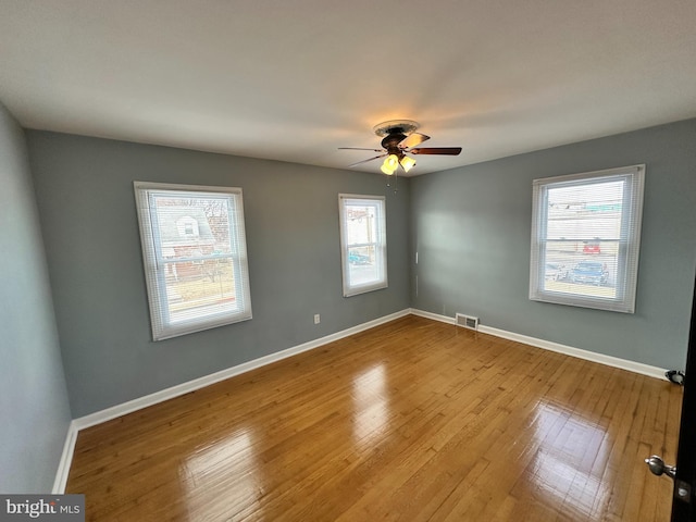 spare room featuring light hardwood / wood-style floors and ceiling fan