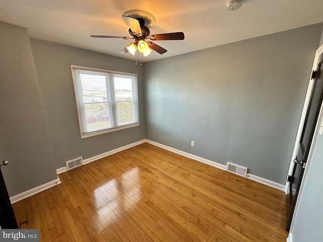 unfurnished room with ceiling fan and light wood-type flooring