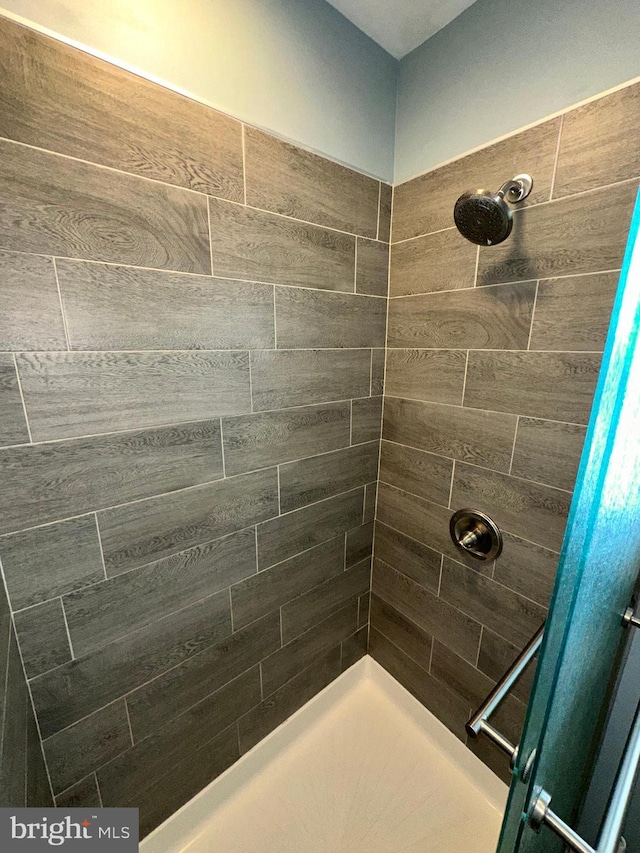 bathroom with tiled shower