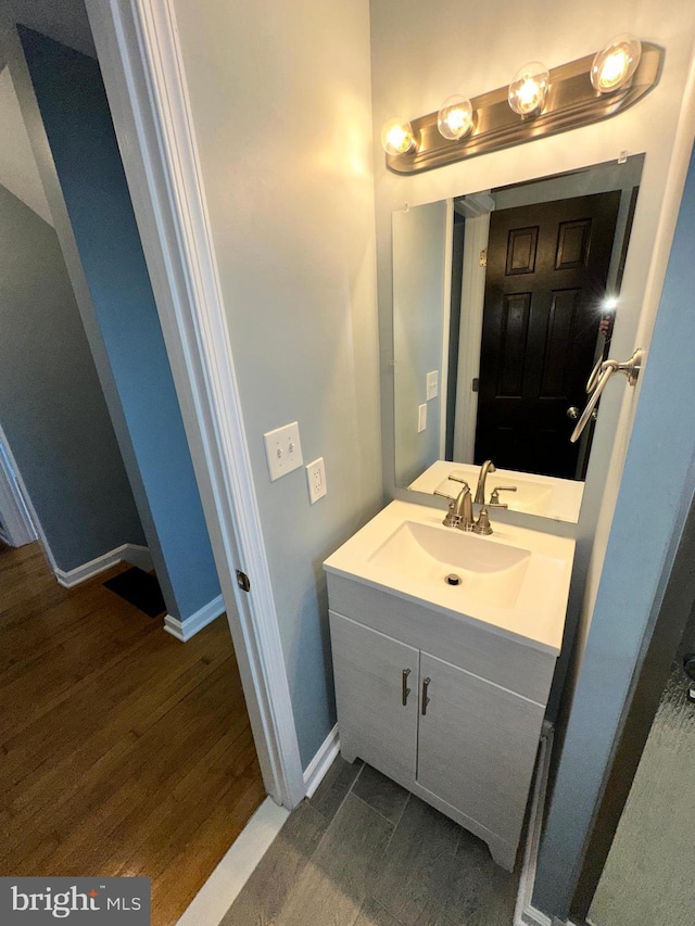 bathroom featuring hardwood / wood-style flooring and vanity