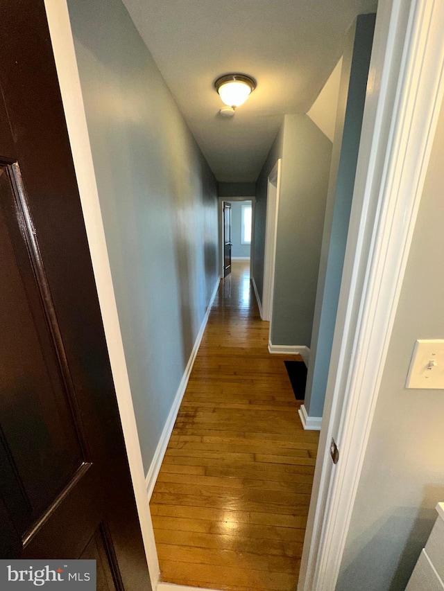 hallway featuring wood-type flooring