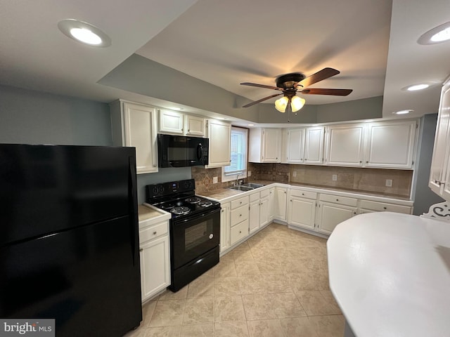 kitchen featuring sink, ceiling fan, white cabinetry, backsplash, and black appliances