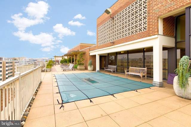view of pool featuring a patio and a covered pool