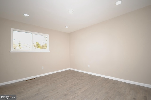 spare room with hardwood / wood-style floors